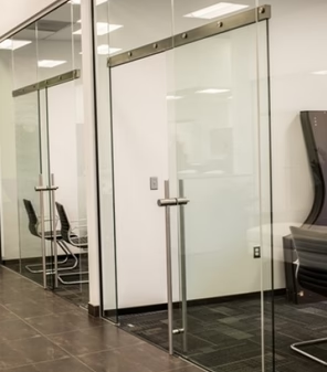 Minimalist frameless glass door with silver security mounting brackets