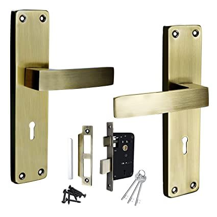 The complex internal components of a mechanical mortise lock, removed from the door. The housing is a rectangular metal box containing gears, springs, and levers that connect the spindle, which operates the handle, to the latch and deadbolt mechanism.